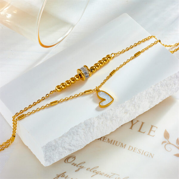 1344f47c-f28f-45b4-9587-c24d6bc3dc8c.jpg Boho Heart Tassel Anklet – Double Layer Chain