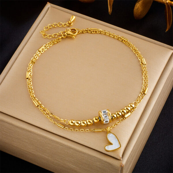 345c108e-9eda-46ac-8030-d31ea7eb2491.jpg Boho Heart Tassel Anklet – Double Layer Chain
