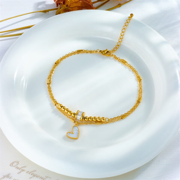 b59401ef-5a90-4769-a3c2-0d8c0cfb2248.jpg Boho Heart Tassel Anklet – Double Layer Chain
